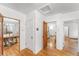 Hallway with hardwood floors leading to the dining room and living room at 6023 E 6Th Avenue Pkwy, Denver, CO 80220
