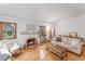 Cozy living room with a brick fireplace, hardwood floors, and neutral decor at 6023 E 6Th Avenue Pkwy, Denver, CO 80220