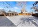 Large backyard with a snow covered lawn and detached garage at 914 Quari Ct, Aurora, CO 80011