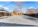 Snow-covered backyard with covered patio and detached garage visible at 914 Quari Ct, Aurora, CO 80011