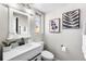 Modern bathroom with white vanity, toilet and black fixtures at 914 Quari Ct, Aurora, CO 80011