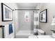 Updated bathroom with a shower/tub combo and gray-striped curtain at 914 Quari Ct, Aurora, CO 80011