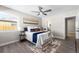 Primary bedroom with ceiling fan, large window and rug at 914 Quari Ct, Aurora, CO 80011