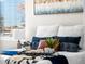 Close-up of a nicely staged bed featuring decorative pillows, a blanket, and a bedside table at 914 Quari Ct, Aurora, CO 80011