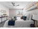 Main bedroom featuring a ceiling fan, large window, and stylish decor at 914 Quari Ct, Aurora, CO 80011