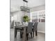 Bright dining area with a rustic table and modern light fixture at 914 Quari Ct, Aurora, CO 80011