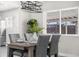 Modern farmhouse dining room with gray chairs and a stylish chandelier at 914 Quari Ct, Aurora, CO 80011