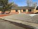 Brick ranch home with landscaped yard and gravel driveway at 914 Quari Ct, Aurora, CO 80011