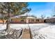 Brick ranch home with snow-covered yard at 914 Quari Ct, Aurora, CO 80011