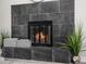 Modern fireplace with dark tile surround at 914 Quari Ct, Aurora, CO 80011