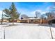 Front yard view of a ranch style home with snow covered lawn at 914 Quari Ct, Aurora, CO 80011