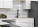 Modern kitchen with white cabinets and a sleek black faucet at 914 Quari Ct, Aurora, CO 80011