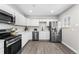 Modern kitchen with white cabinets, stainless steel appliances, and a subway tile backsplash at 914 Quari Ct, Aurora, CO 80011