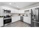 Modern kitchen with white cabinets, stainless steel appliances, and a subway tile backsplash at 914 Quari Ct, Aurora, CO 80011