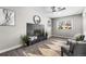 Living room showcasing a tiled fireplace, neutral paint, ceiling fan, and a large window at 914 Quari Ct, Aurora, CO 80011