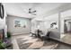 Cozy living room featuring a ceiling fan, neutral paint, and a large window for natural light at 914 Quari Ct, Aurora, CO 80011