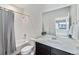 Bathroom with a shower/tub combo, vanity sink, and a large mirror at 12336 W 52Nd Ave, Wheat Ridge, CO 80033