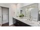 Bathroom featuring double sinks, a large mirror, and a separate shower at 12336 W 52Nd Ave, Wheat Ridge, CO 80033