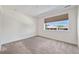 Bright bedroom with neutral carpet, a large window, and white walls at 12336 W 52Nd Ave, Wheat Ridge, CO 80033