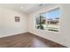 Bright bedroom with hardwood floors, a large window, and white walls at 12336 W 52Nd Ave, Wheat Ridge, CO 80033