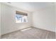 Bright bedroom with neutral carpet, a large window, and white walls at 12336 W 52Nd Ave, Wheat Ridge, CO 80033