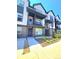 Modern townhouse with a black and white exterior, a small yard, and a front porch at 12336 W 52Nd Ave, Wheat Ridge, CO 80033