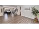 Open-concept living room with hardwood floors and a view of the kitchen and staircase at 12336 W 52Nd Ave, Wheat Ridge, CO 80033
