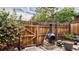 Cozy fenced backyard featuring a charming chiminea, lush greenery, and a tranquil ambiance at 3616 W Radcliff Ave, Denver, CO 80236