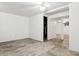 Open basement with a ceiling fan, white walls, and concrete floors, ready for customization at 3616 W Radcliff Ave, Denver, CO 80236