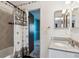 Bright bathroom featuring a tub/shower combo and granite countertop at 3616 W Radcliff Ave, Denver, CO 80236
