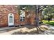 Charming brick townhouse featuring a white front door and meticulously maintained landscaping at 3616 W Radcliff Ave, Denver, CO 80236