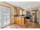 Well-lit kitchen with stainless steel appliances and granite countertops, and an island at 3616 W Radcliff Ave, Denver, CO 80236