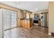 Bright eat-in kitchen featuring stainless steel appliances and wood flooring at 3616 W Radcliff Ave, Denver, CO 80236