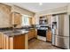 Bright kitchen with stainless steel appliances, modern cabinetry, and countertops at 3616 W Radcliff Ave, Denver, CO 80236