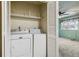 Convenient laundry closet includes washer and dryer units and storage shelves at 3616 W Radcliff Ave, Denver, CO 80236