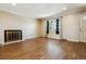 Bright living room featuring hardwood floors, a fireplace, and a front door at 3616 W Radcliff Ave, Denver, CO 80236