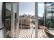 Balcony view of downtown through open doors, featuring seating and skyline views at 1700 Bassett St # 1808, Denver, CO 80202