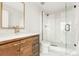 Modern bathroom with walk-in shower, wood vanity, and marble floors at 1700 Bassett St # 1808, Denver, CO 80202