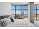 Bedroom with cityscape views through large windows and a queen size bed at 1700 Bassett St # 1808, Denver, CO 80202