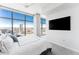 Bedroom with a large window offering city views, TV, and carpeted floors at 1700 Bassett St # 1808, Denver, CO 80202