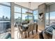 Dining area with a view of the city, exposed concrete, and seating for six at 1700 Bassett St # 1808, Denver, CO 80202