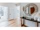 Inviting hallway with hardwood floors, a decorative mirror, and access to various rooms at 1700 Bassett St # 1808, Denver, CO 80202