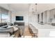 Inviting living area with a modern kitchen island, plush seating, and picturesque mountain views at 1700 Bassett St # 1808, Denver, CO 80202