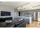 Bright, modern living room featuring wood floors, an open kitchen, and a comfortable seating area at 1700 Bassett St # 1808, Denver, CO 80202