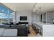Modern living room featuring a sleek leather sofa, hardwood floors, and stunning city views through expansive windows at 1700 Bassett St # 1808, Denver, CO 80202