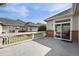 Concrete back patio area with brick siding accents and backyard views at 3205 E 102Nd Pl, Thornton, CO 80229