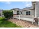 Backyard landscaping with grey siding, brick accents, and sliding glass doors at 3205 E 102Nd Pl, Thornton, CO 80229