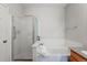 Bathroom featuring large tub with decorative tile and a glass enclosed shower at 3205 E 102Nd Pl, Thornton, CO 80229