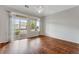 Large bedroom features balcony access with abundant light and hardwood floors at 3205 E 102Nd Pl, Thornton, CO 80229