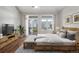 Spacious main bedroom with balcony access, area rug, and modern decor at 3205 E 102Nd Pl, Thornton, CO 80229